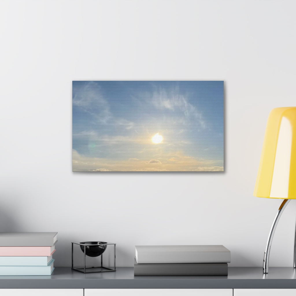 Wall-mounted canvas print with sunrise sky, glowing sun and soft clouds in blue and gold tones