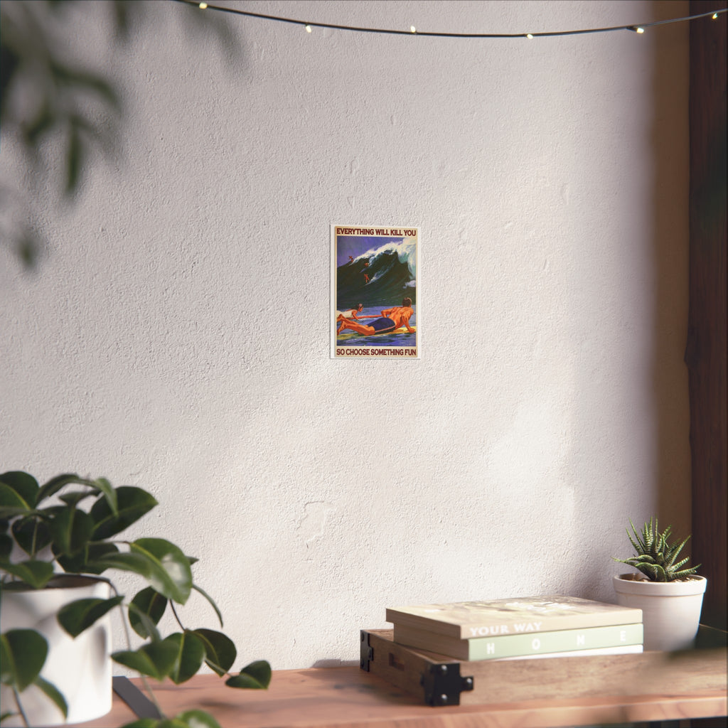 Framed wall poster with surf riders and quote text, displayed above wooden tabletop